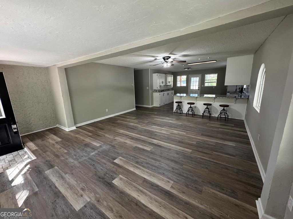 5781 Adams Road Valdosta, GA 31601 - Photo 20 of 27 a view of a livingroom with hardwood floor and a ceiling fan