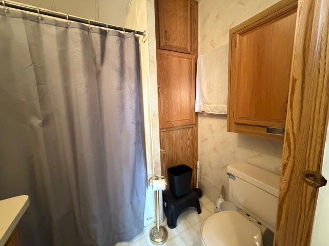2795 East 28th Road Marseilles, IL 61341 - Photo 21 of 69 a bathroom with a sink a toilet a mirror and shower curtain