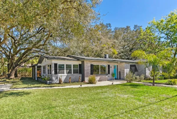 a view of a house with a backyard porch and sitting area