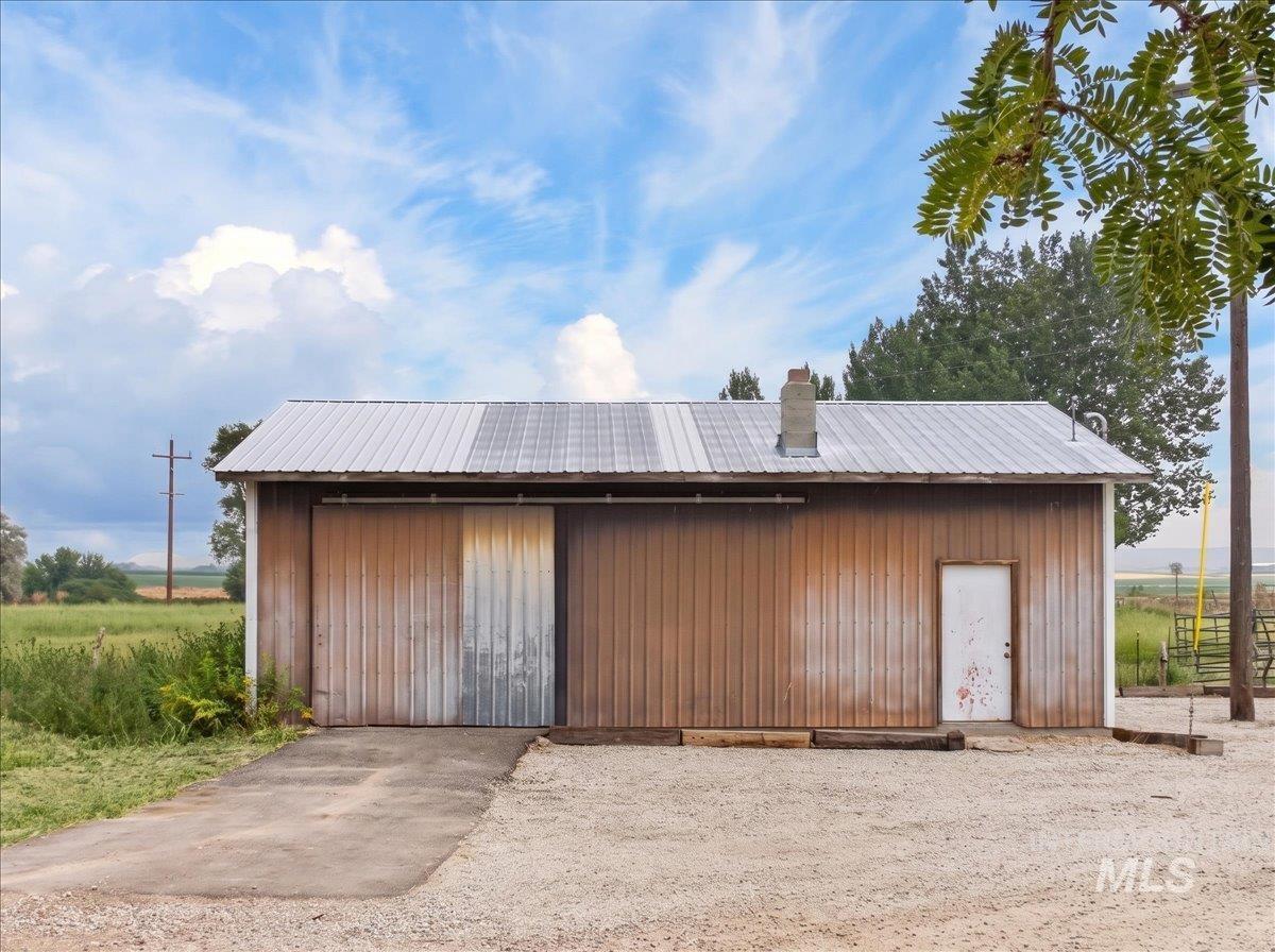 8989 Hillview Road Emmett, ID 83617 - Photo 5 of 50 Single-story residence featuring light-colored siding, a dark asphalt shingle roof, and a gravel driveway