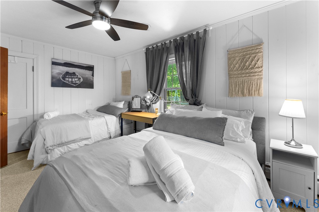 437 Plainview Road Kinsale, VA 22488 - Photo 42 of 63 a bedroom with two beds and a large mirror