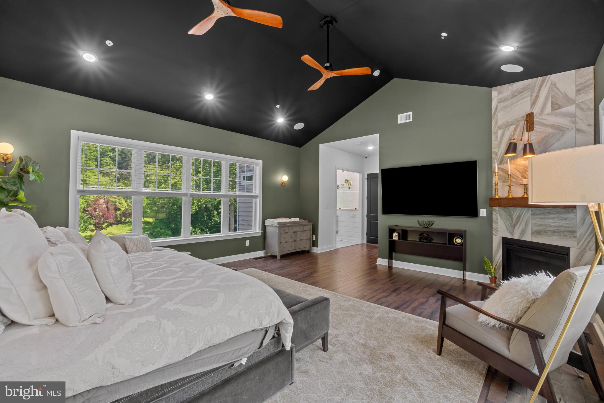 10907 Hollow Road Cockeysville, MD 21030 - Photo 31 of 57 a spacious bedroom with a bed and a flat screen tv