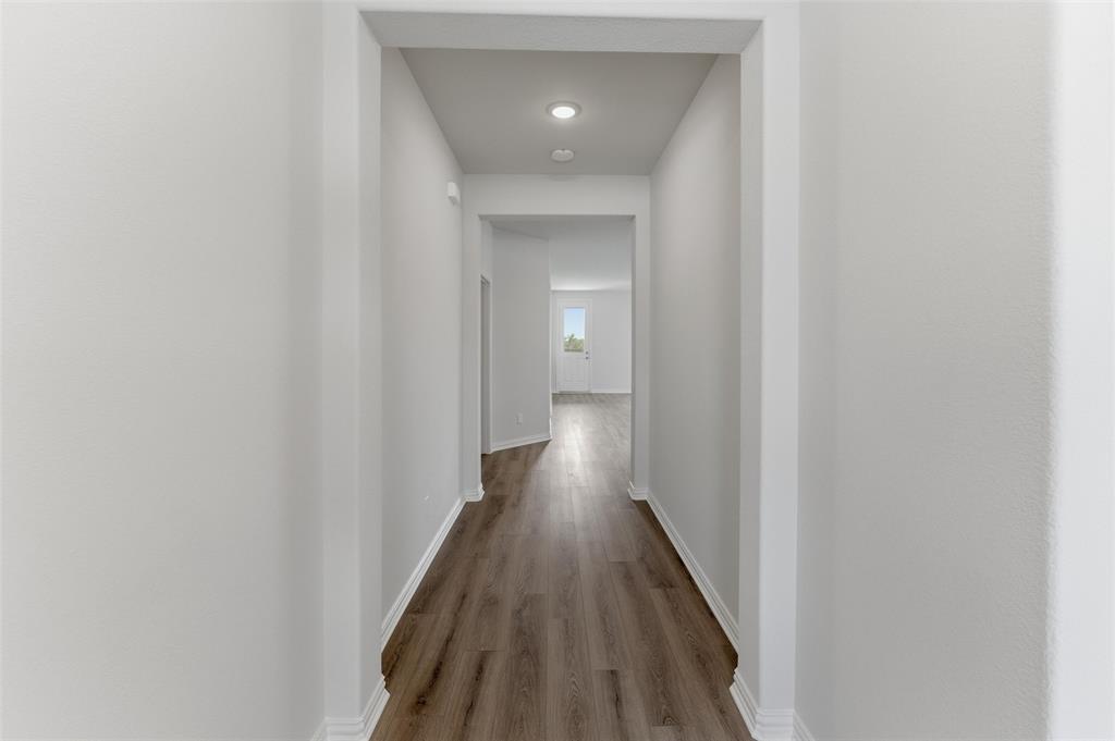 3504 Helena Street Gainesville, TX 76240 - Photo 5 of 19 Hallway featuring wood-finish flooring, recessed lighting, white baseboards, and neutral wall finishes