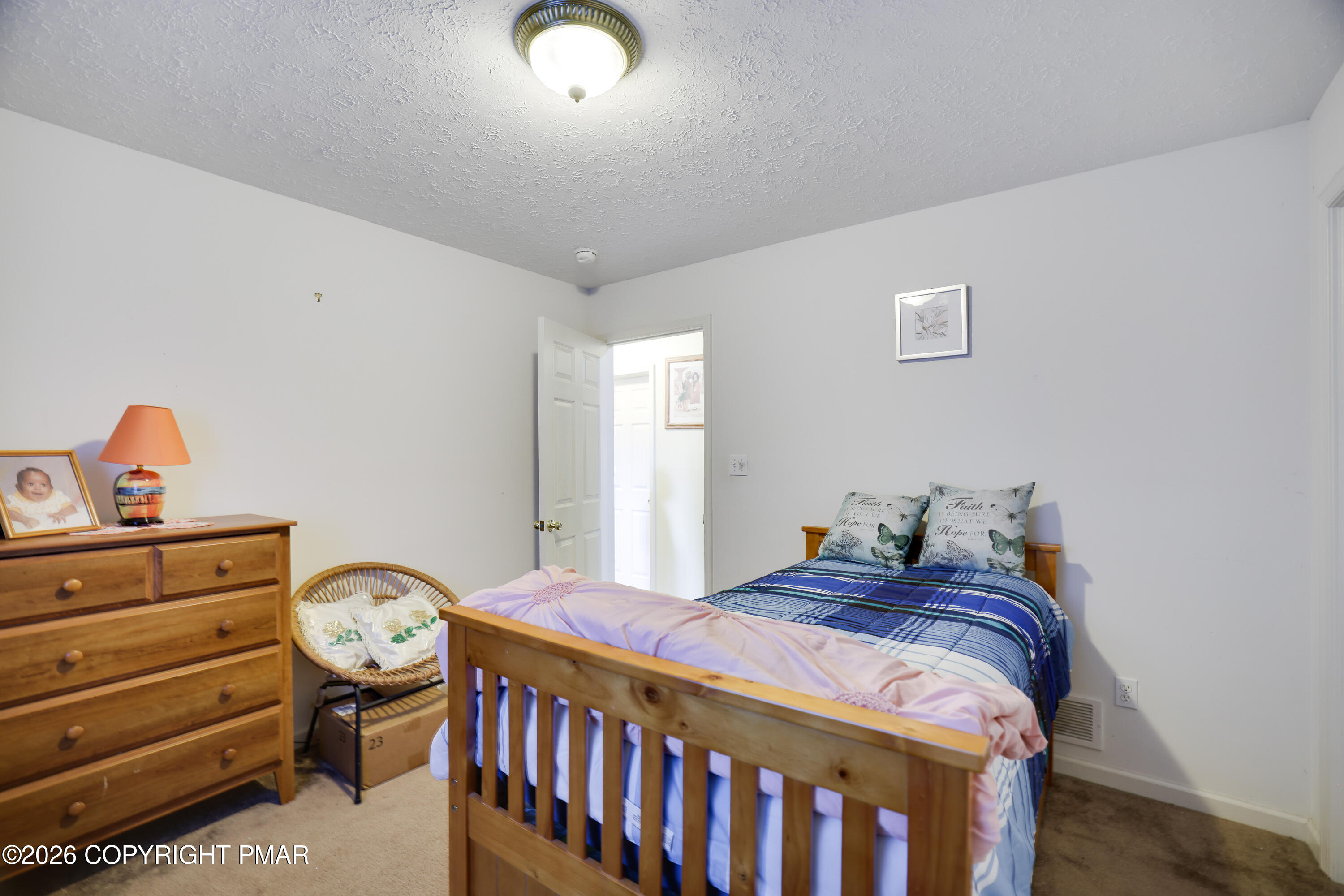 2137 Freedom Way Pocono Summit, PA 18346 - Photo 26 of 71 a bed sitting in a bedroom next to a window