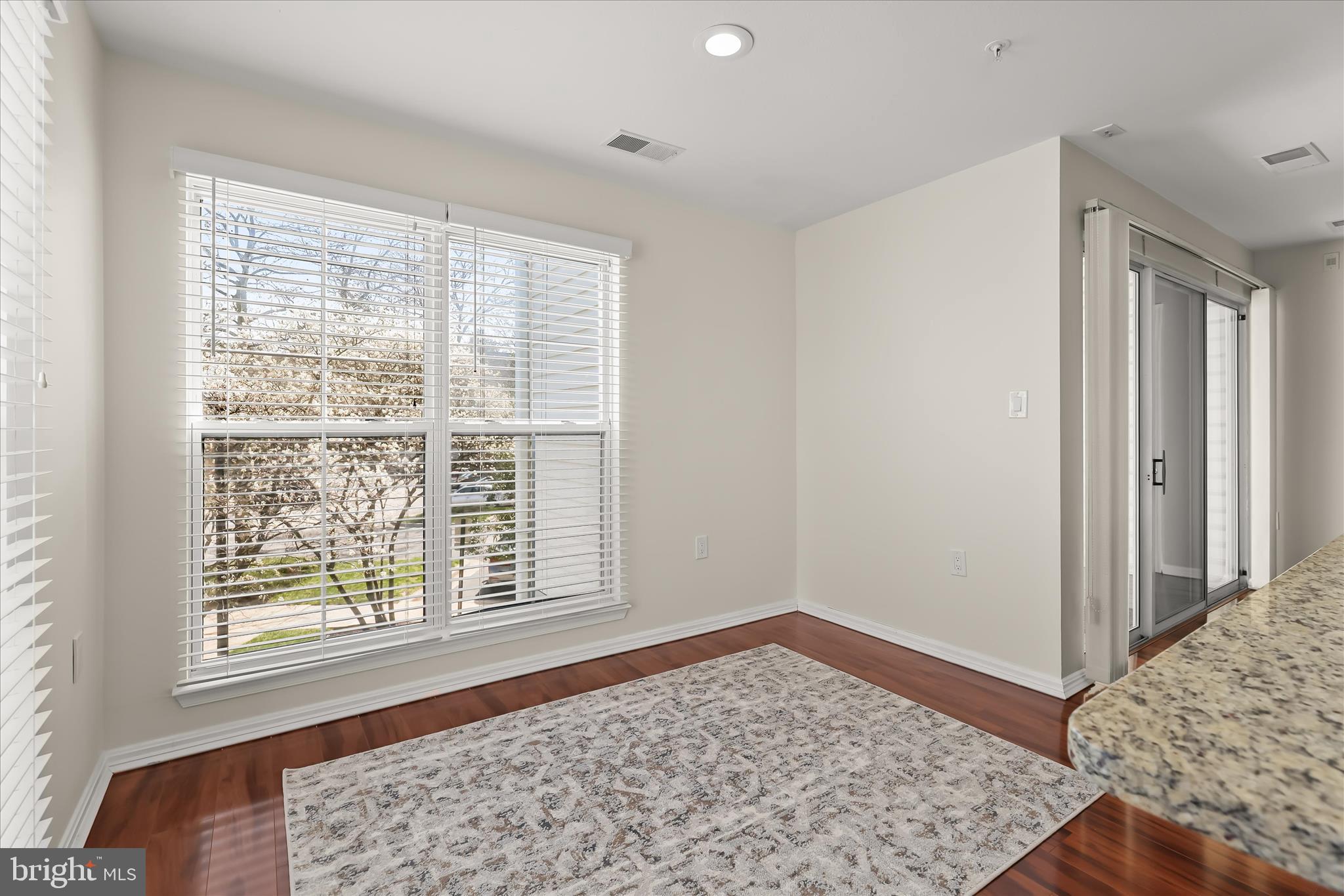3555 Floating Leaf Lane, Unit C201 Laurel, MD 20724 - Photo 15 of 37 a view of a bedroom with a bed and wooden floor