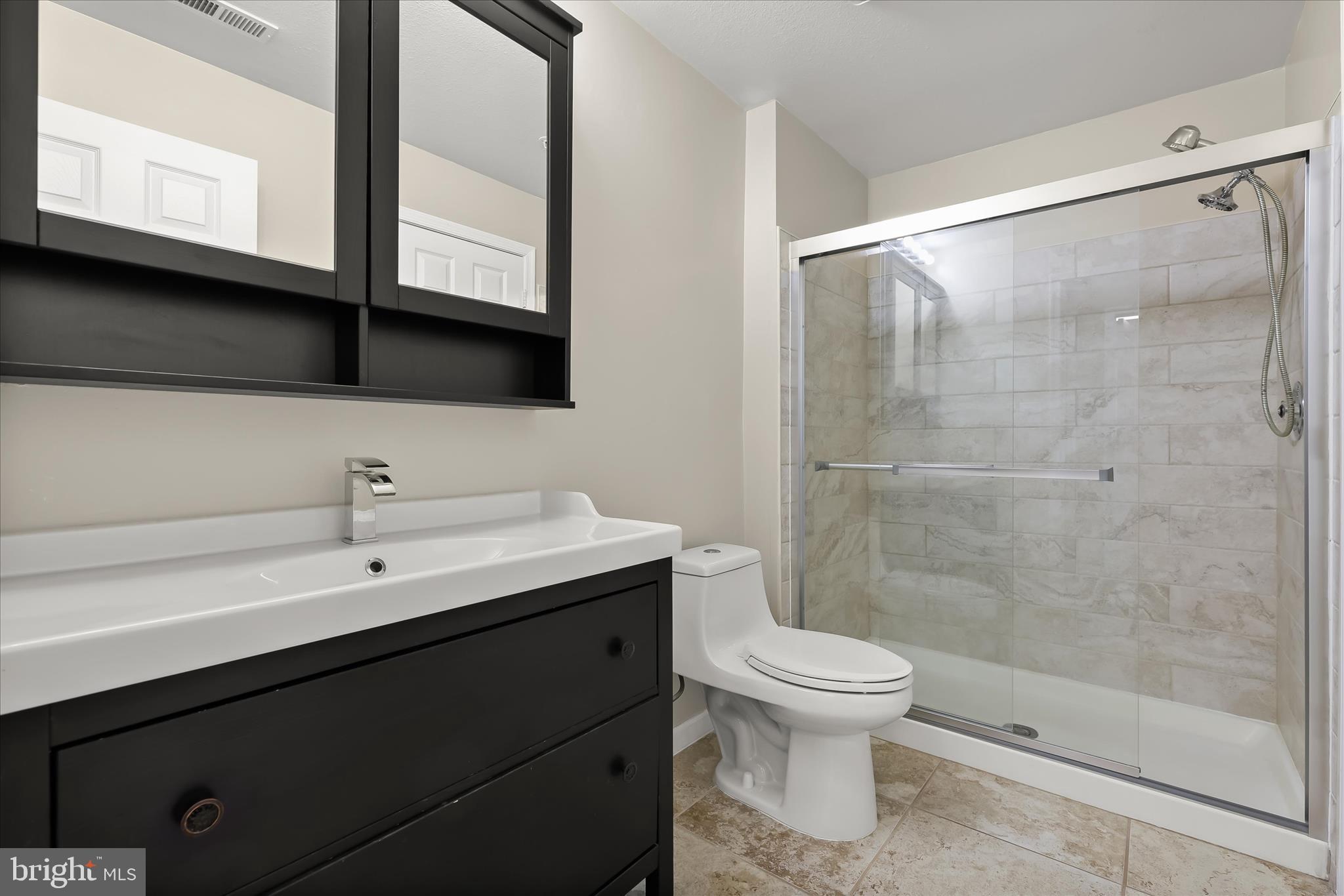 3555 Floating Leaf Lane, Unit C201 Laurel, MD 20724 - Photo 23 of 37 a bathroom with a sink a toilet and shower