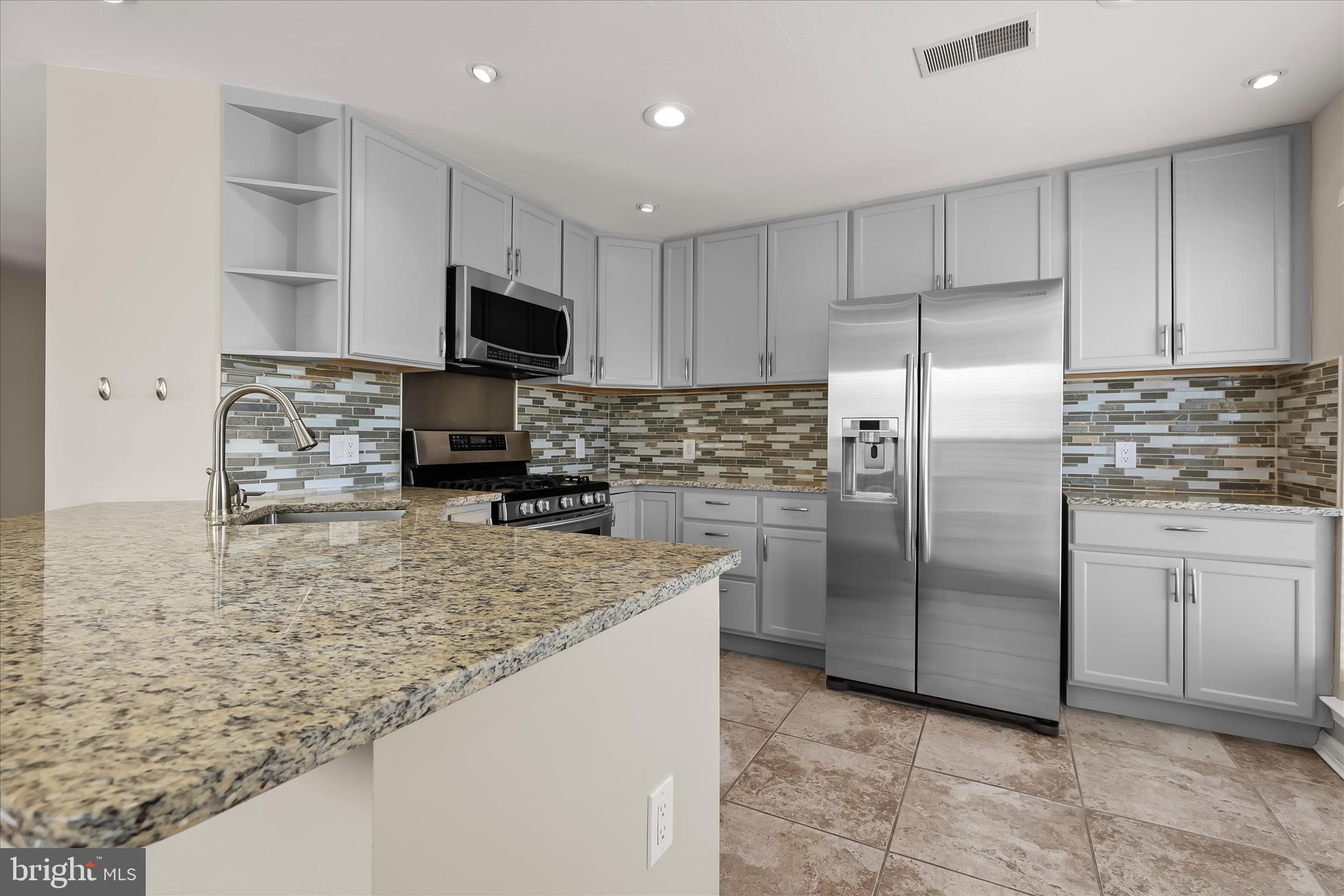3555 Floating Leaf Lane, Unit C201 Laurel, MD 20724 - Photo 3 of 37 a kitchen with stainless steel appliances granite countertop a refrigerator a stove a sink and a microwave