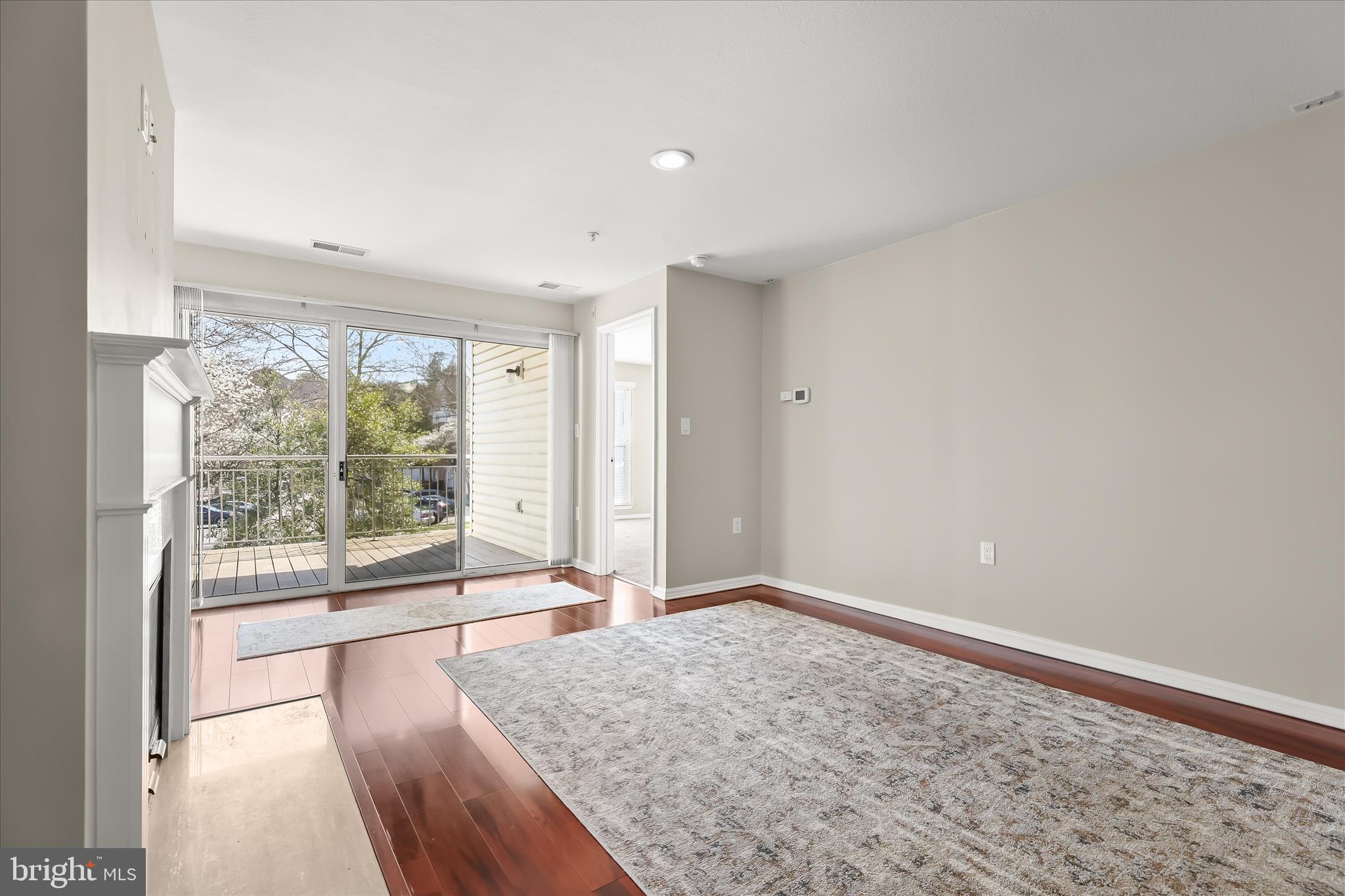 3555 Floating Leaf Lane, Unit C201 Laurel, MD 20724 - Photo 8 of 37 a view of an empty room with wooden floor and a window