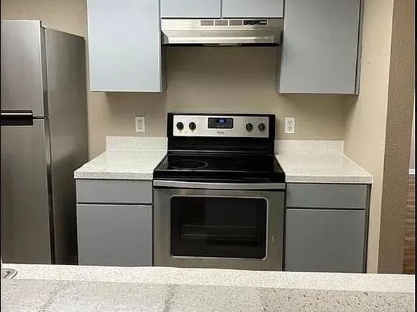 a kitchen with a stove and a refrigerator