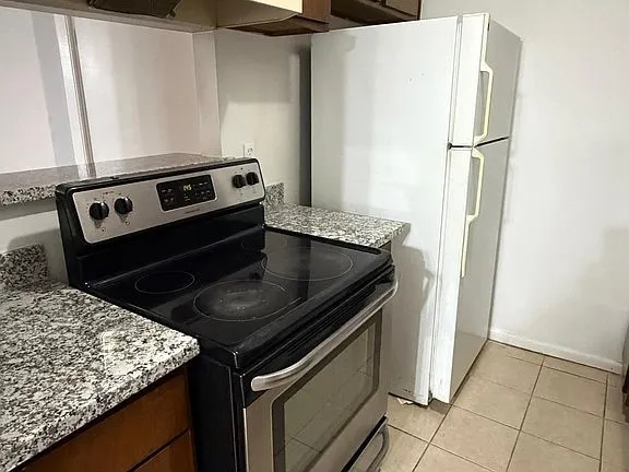 a kitchen with a stove and a refrigerator