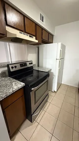 a stove top oven sitting inside of a kitchen