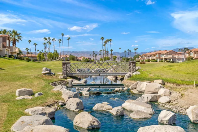 a view of a patio with couches and a table and chairs with potted plants