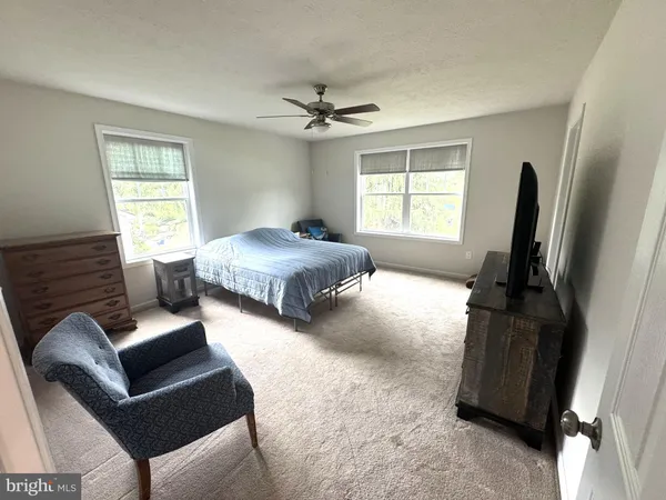a bedroom with a bed furniture and a window