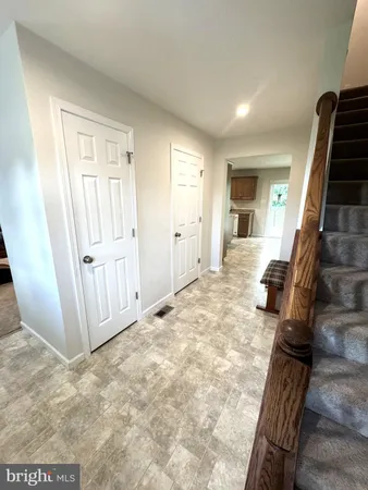 a view of a livingroom with wooden floor and stairs