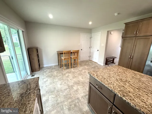 a view of kitchen and refrigerator