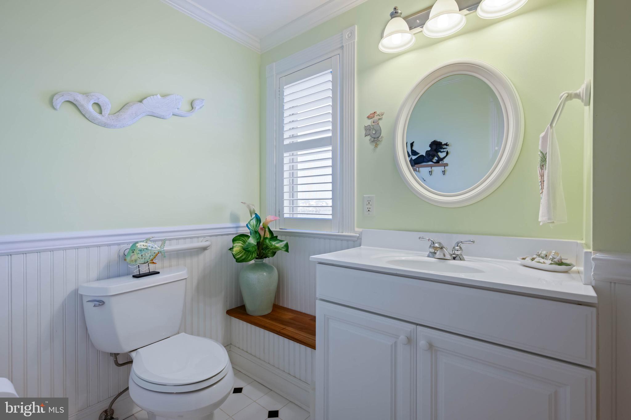 12959 Harbor Road Ocean City, MD 21842 - Photo 54 of 85 a bathroom with a toilet a sink and a mirror