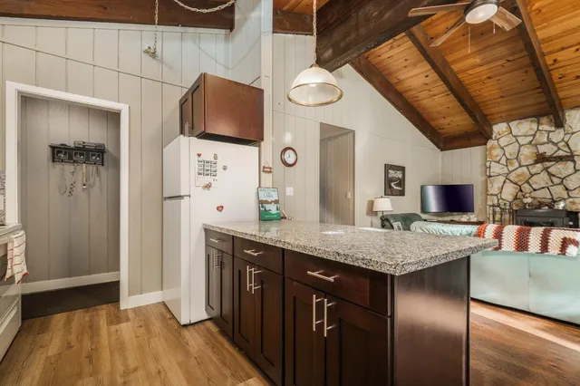 a kitchen with stainless steel appliances granite countertop a sink and wooden cabinets