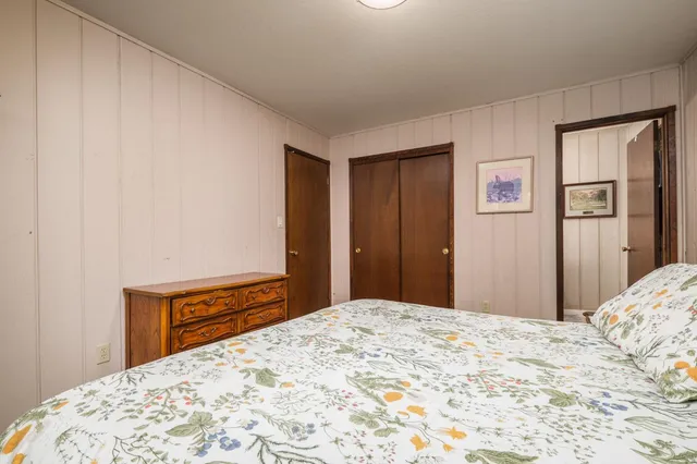 a bedroom with a bed and a dresser