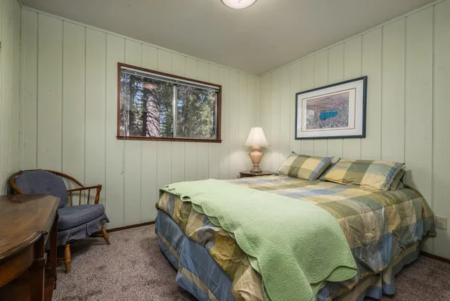 a bedroom with a bed and a table in it