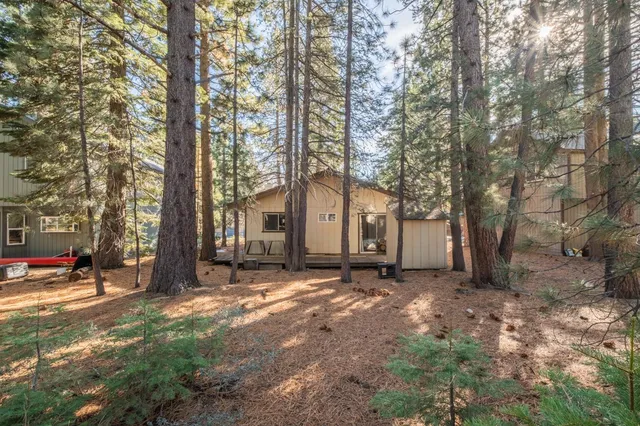 a view of a house with a yard covered in snow