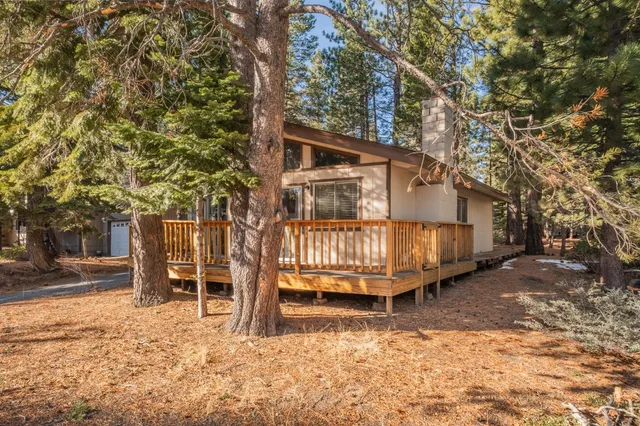 a view of a yard with large trees