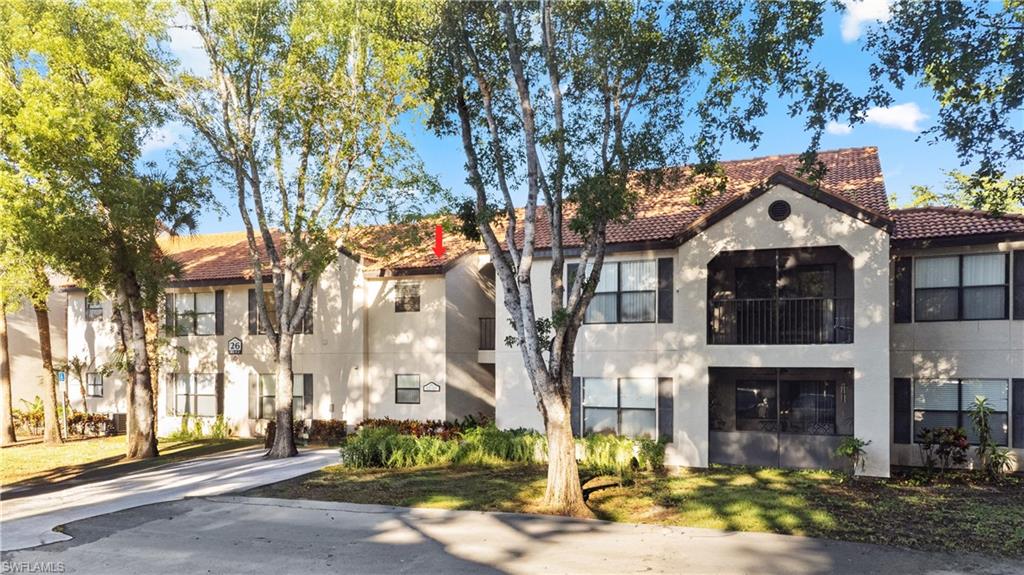 2142 Arbour Walk Circle, Unit 2626 Naples, FL 34109 - Photo 1 of 20 a front view of a building with street view