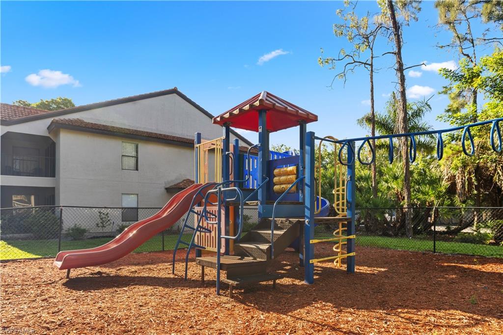 2142 Arbour Walk Circle, Unit 2626 Naples, FL 34109 - Photo 18 of 20 a view of a house with a park