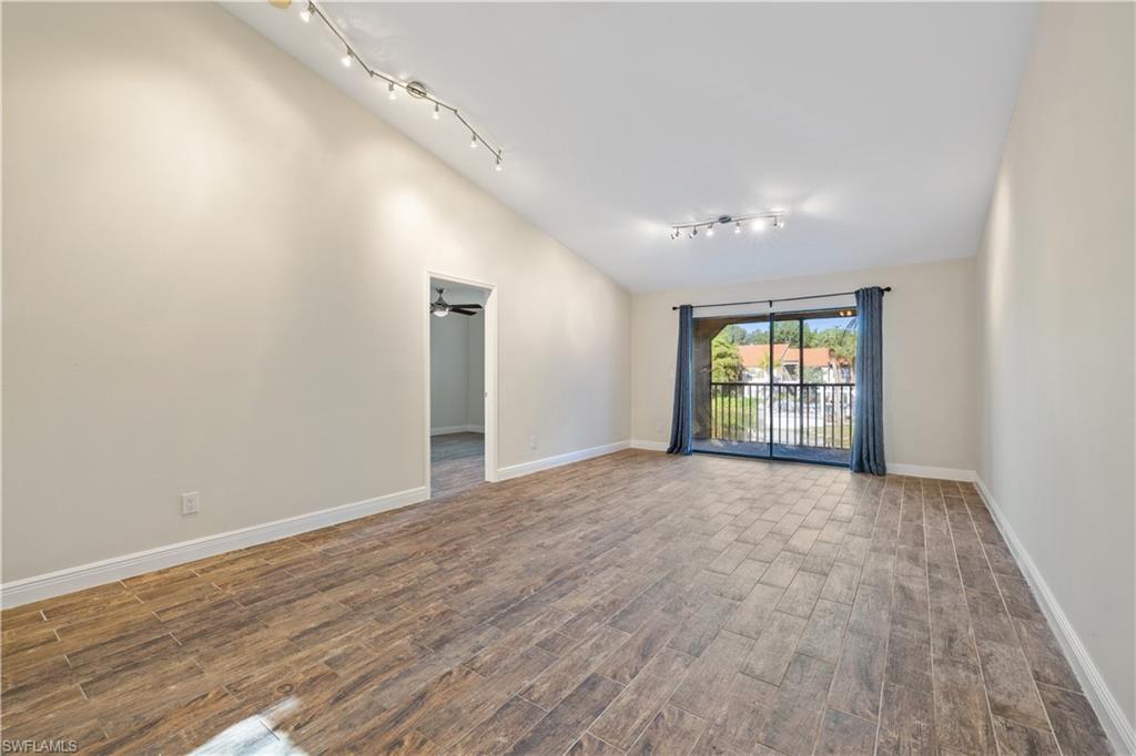 2142 Arbour Walk Circle, Unit 2626 Naples, FL 34109 - Photo 2 of 20 a view of an empty room with wooden floor and a window