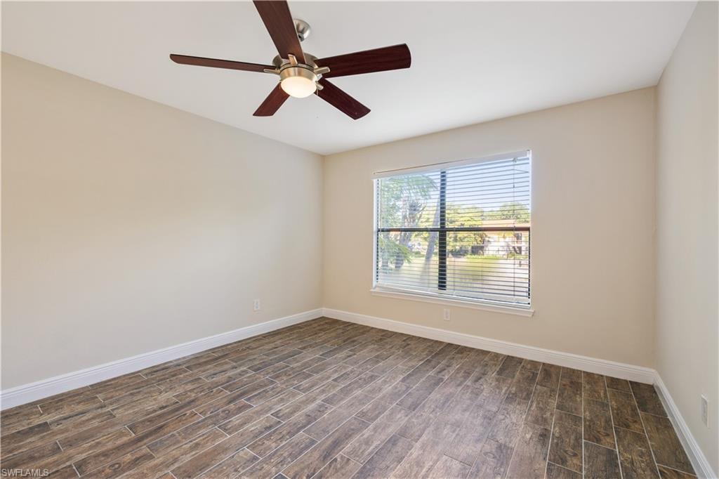 2142 Arbour Walk Circle, Unit 2626 Naples, FL 34109 - Photo 7 of 20 an empty room with wooden floor fan and windows