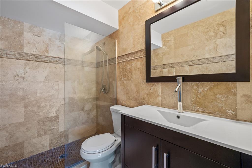 2142 Arbour Walk Circle, Unit 2626 Naples, FL 34109 - Photo 10 of 20 a bathroom with a sink a toilet and shower