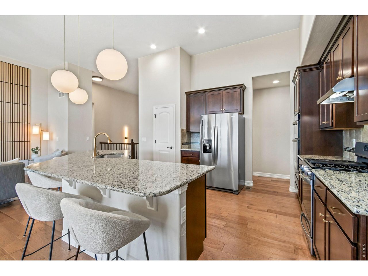 5531 Teeling Court Timnath, CO 80547 - Photo 15 of 48 a kitchen with stainless steel appliances granite countertop a sink a stove and a refrigerator