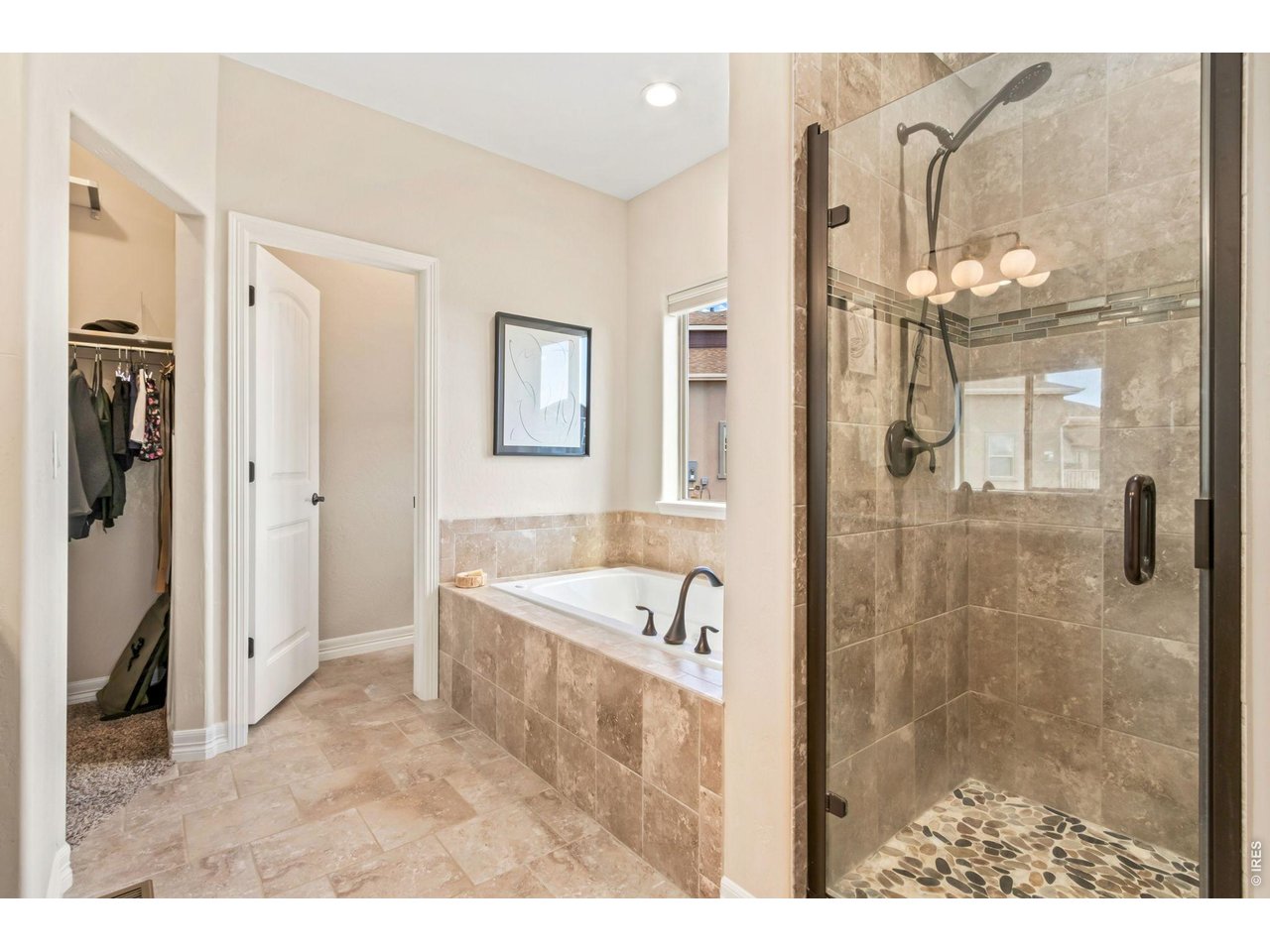 5531 Teeling Court Timnath, CO 80547 - Photo 24 of 48 a bathroom with a tub sink shower and mirror