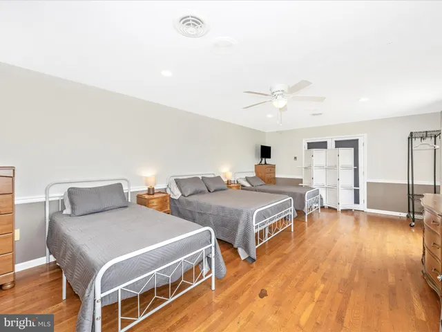 a bedroom with two beds and a chandelier