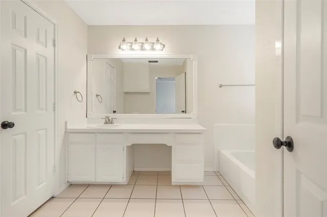 a bathroom with a sink a mirror and a bathtub