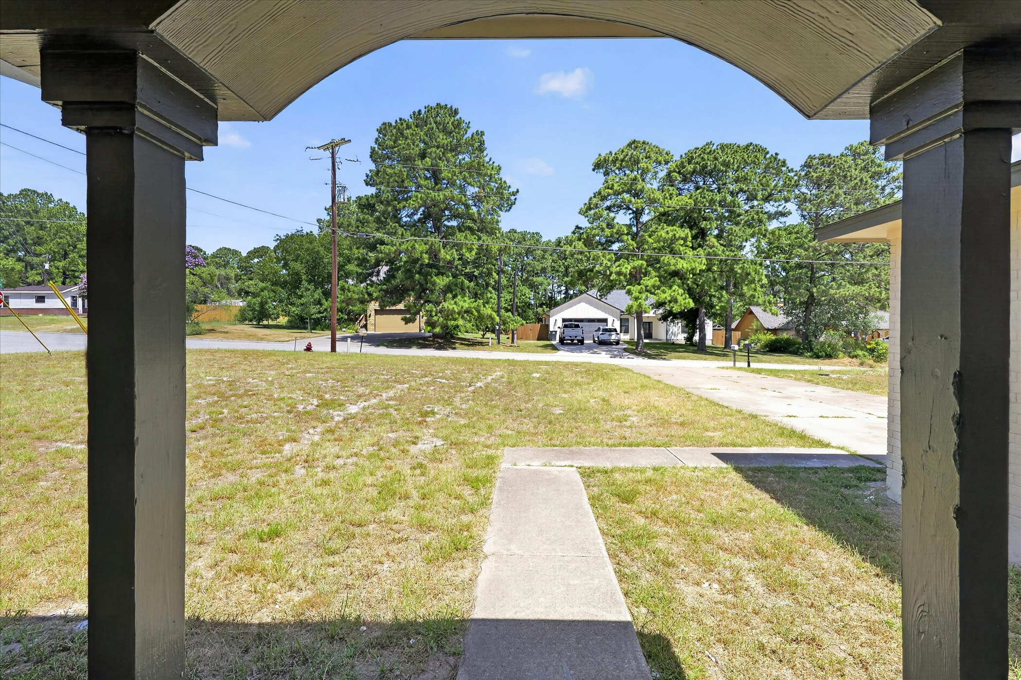 258 Pine View Loop Bastrop, TX 78602 - Photo 6 of 40 A deep front porch invites relaxation while overlooking a spacious front yard and neighboring homes.