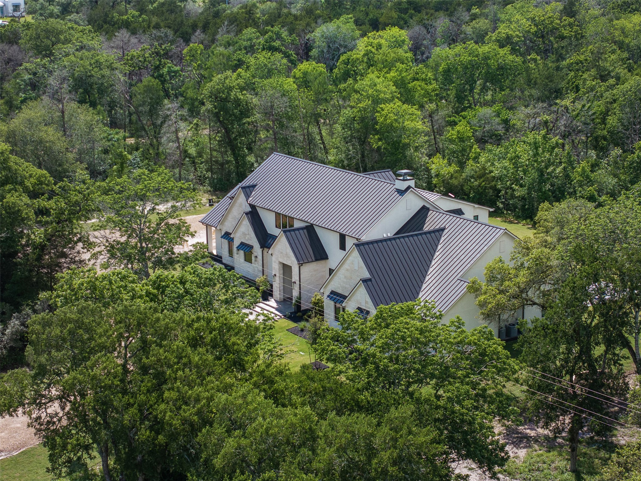 770 South Weyand Road Round Top, TX 78954 - Photo 46 of 50 an aerial view of a house with yard and trees in the background