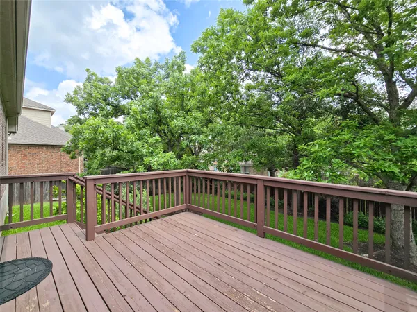 a view of balcony with wooden floor and fence