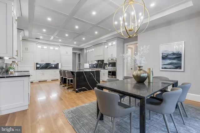 a dining room with furniture and a chandelier