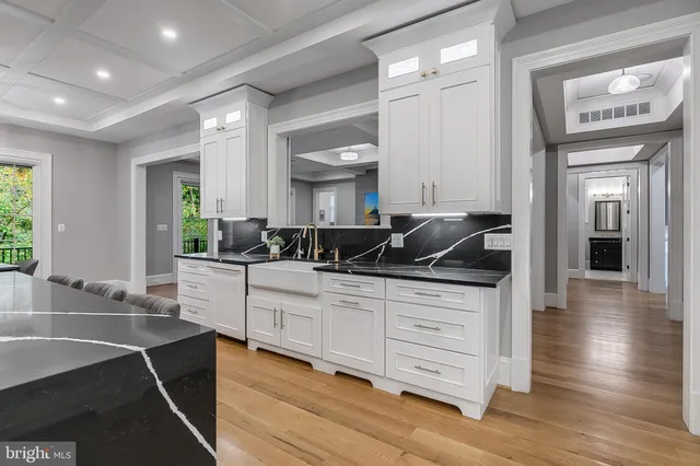 a kitchen with granite countertop a sink and cabinets