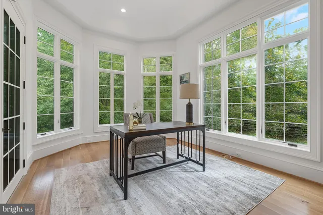 a view of a room with wooden floor and windows