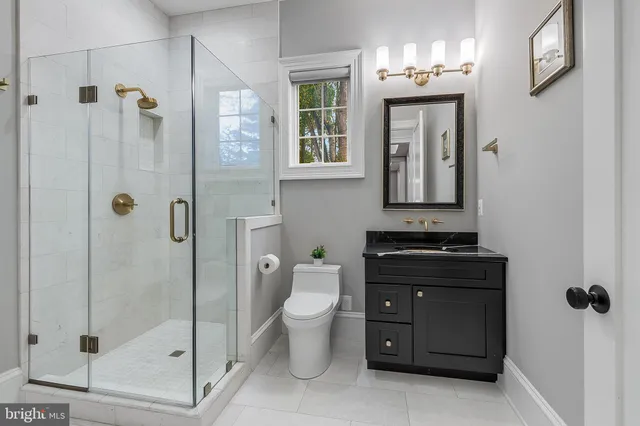 a bathroom with a toilet sink and shower