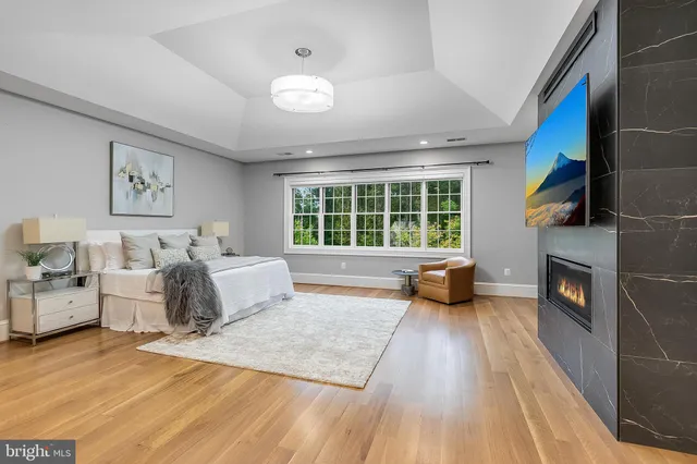 a bedroom with furniture and a fireplace