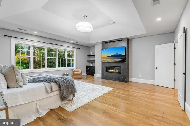 a bed sitting in a spacious bedroom next to a window