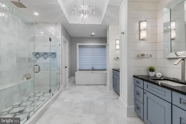 a bathroom with a double vanity sink a toilet and shower