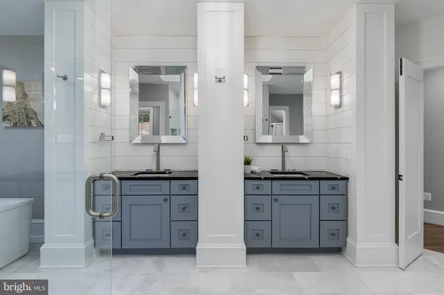 a spacious bathroom with a granite countertop sink a toilet and a mirror