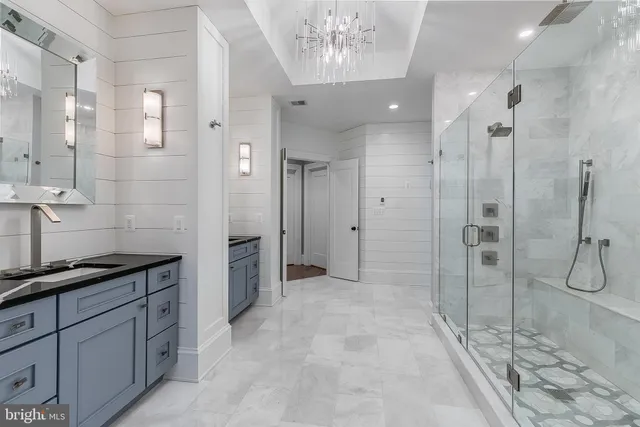 a bathroom with a double vanity sink a toilet and shower