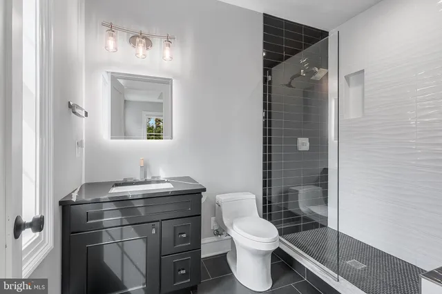 a bathroom with a toilet a sink and shower