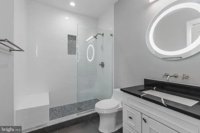 a bathroom with a toilet a sink and shower