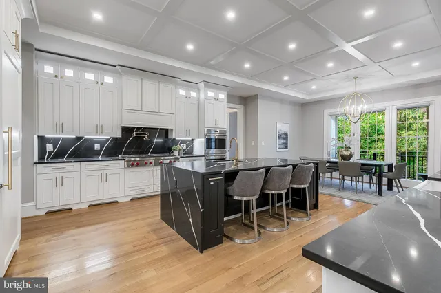 a large kitchen with lots of counter space a dining table and chairs
