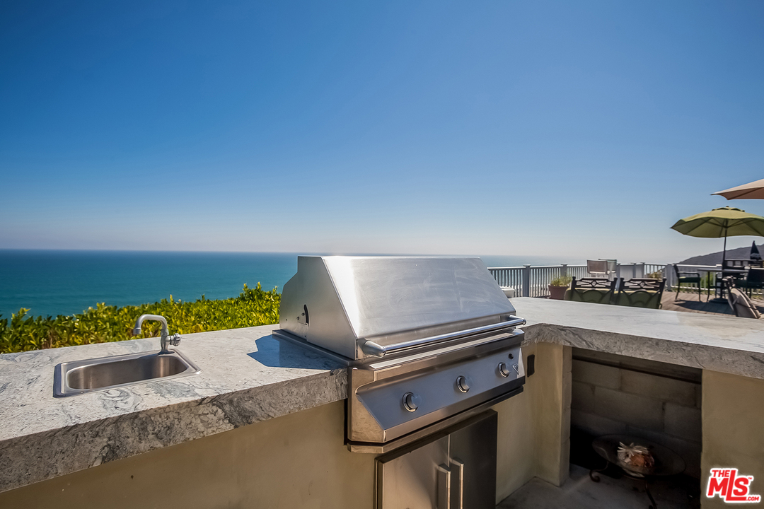 18440 Coastline Drive Malibu, CA 90265 - Photo 18 of 21 a kitchen with a stove and a sink